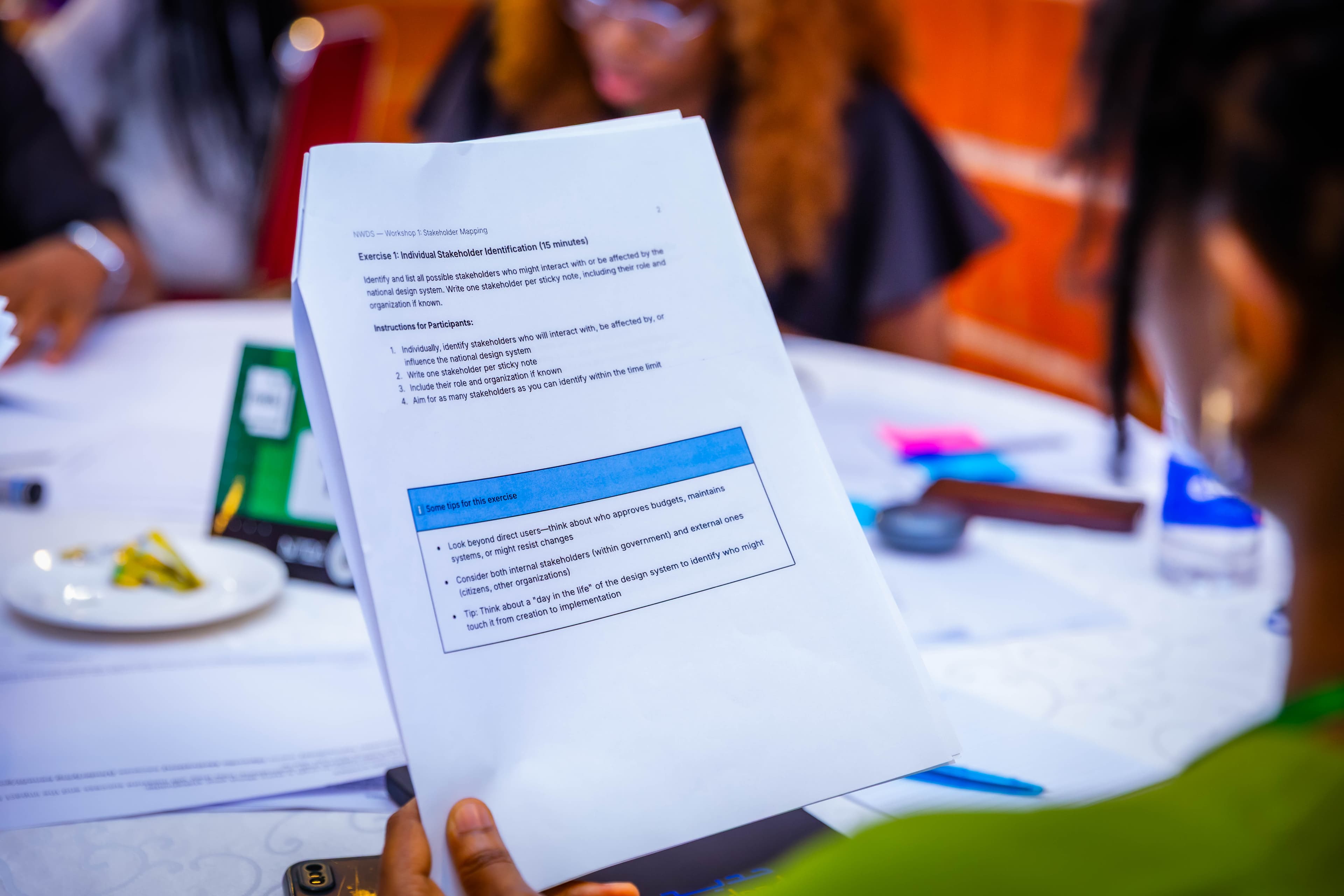 A participant reads the stakeholder mapping exercise sheet from Workshop 1