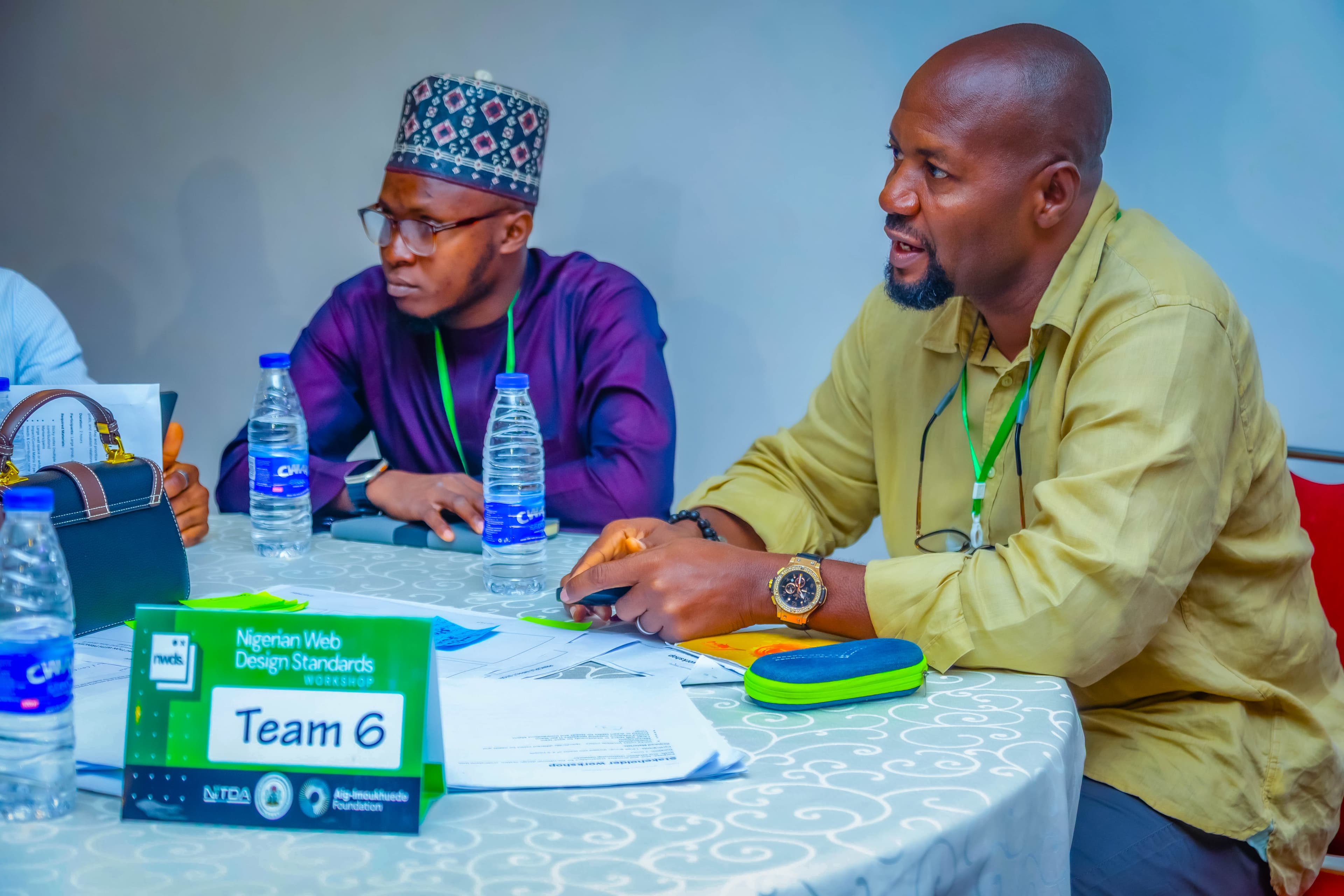 Two participants at the Team 6 table during a working session